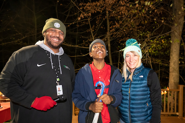 Staff and participant smiling