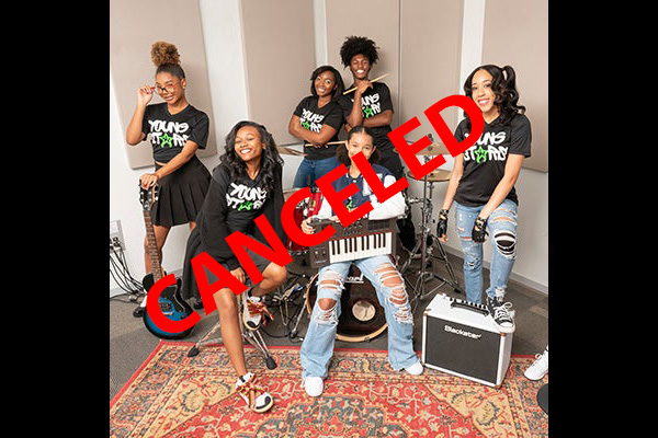 There is red text that reads "CANCELED" over six young women smiling and posing in the corner of a room, amid musical instruments and amps. They all wear black t-shirts that say YOUNG STARS on them.