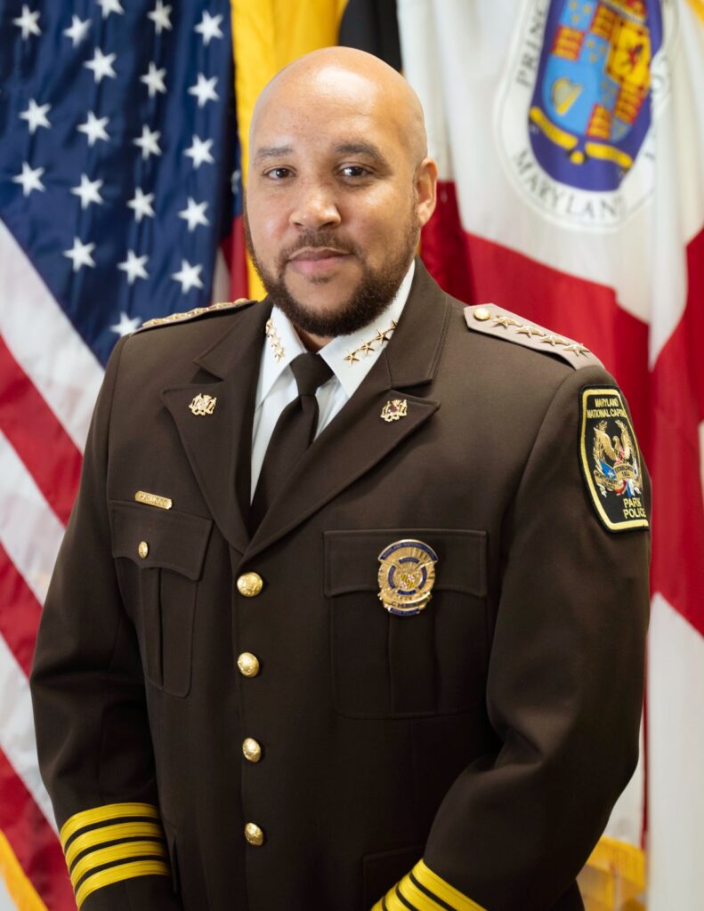 Headshot of a man with a beard wearing a dark brown Park Police uniform.