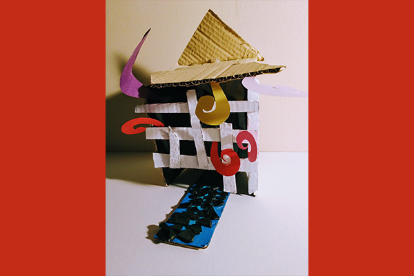 Small, mixed-media sculpture of a shelter with parts made of cardboard and paper.